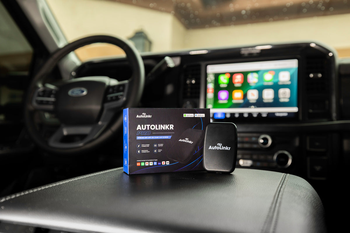 AutoLinkr wireless CarPlay adapter sitting in a car center console